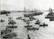 Fotografia de um conjunto de embarcações festivas, por ocasião da visita de estado efetuada por Américo Tomás a Moçambique