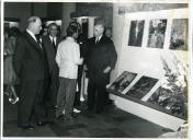Fotografia de Américo Tomás na Junta de Turismo da Costa do Sol, visitando uma exposição de fotografias a cores sobre Angola