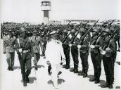 Fotografia de Américo Tomás passando revista às tropas durante a inauguração do aeroporto de Faro, por ocasião da visita oficial efetuada ao Algarve, de 11 a 14 de julho de 1965