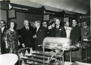 Fotografia de Américo Tomás acompanhado por Gertrudes Rodrigues Tomás, Maria Natália Rodrigues Tomás e por César Moreira Baptista no Secretariado Nacional de Informação visitando uma exposição de decorações para instalações hoteleiras