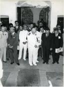 Fotografia de Américo Tomás, acompanhado por António Augusto Peixoto Correia, no interior de uma igreja na Ilha de Moçambique observando uma sepultura rasa por ocasião da visita de estado efetuada a Moçambique